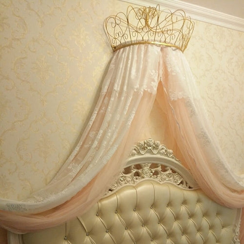 gold and white mosquito net adorns the crown shelf